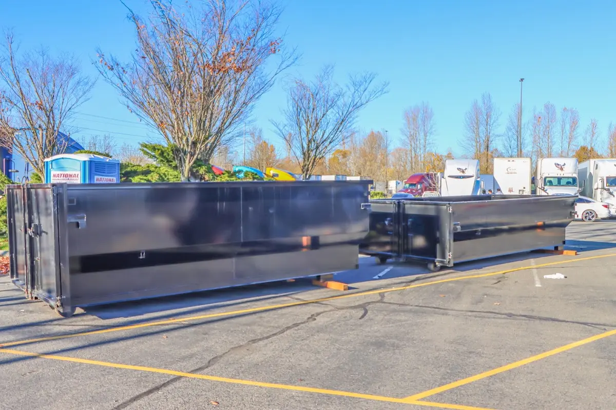 Professional dumpster rental service with roll-off container on residential driveway in Tuba City